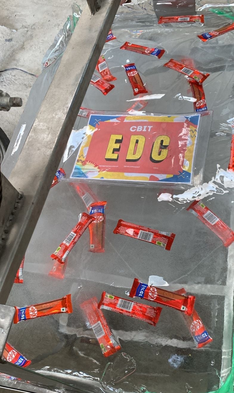 Perfectly clear ice block with embedded chocolate bars and the CBIT EDC logo.